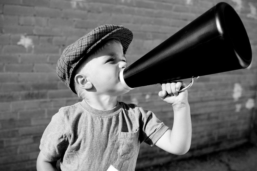 Child shouting through loudspeaker